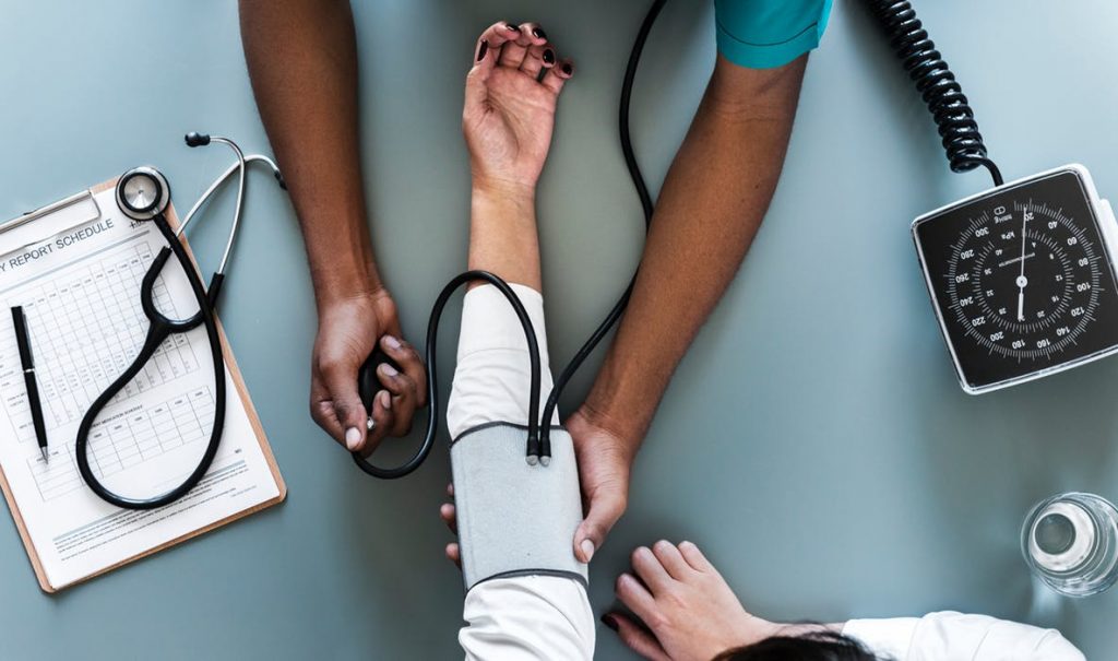 Doctor checking a patient's blood pressure